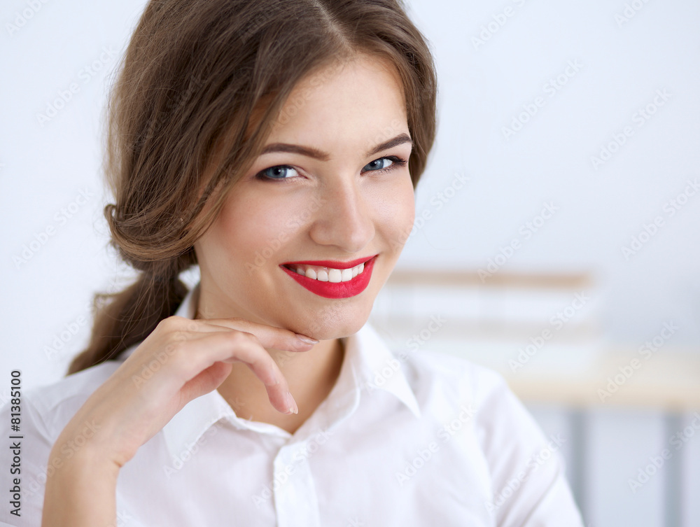 Attractive businesswoman sitting in the office Attractive businesswoman sitting in the office