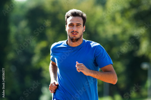 Young man jogging photo