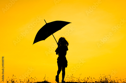 Umbrella girl with sunset silhouette