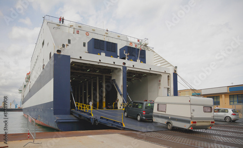 Loading of minibus with trailer on ferry. Ancona, Italy
