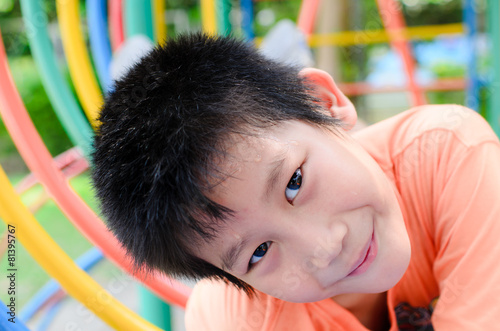 Asian boy enjon with outdoor playground photo