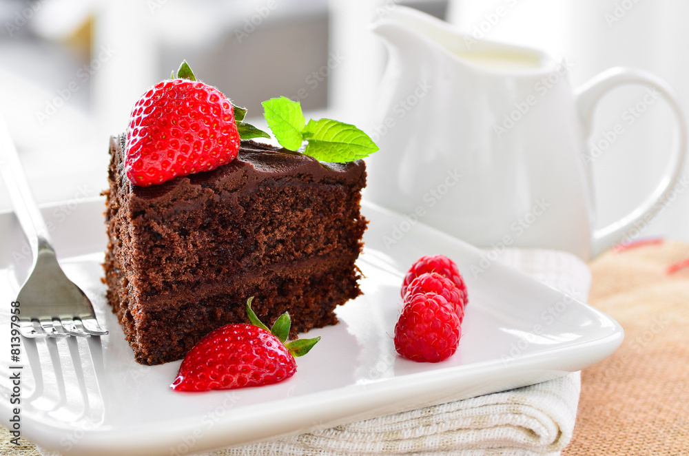 Fresh home made sticky chocolate fudge cake with strawberries Fresh home made sticky chocolate fudge cake with strawberries