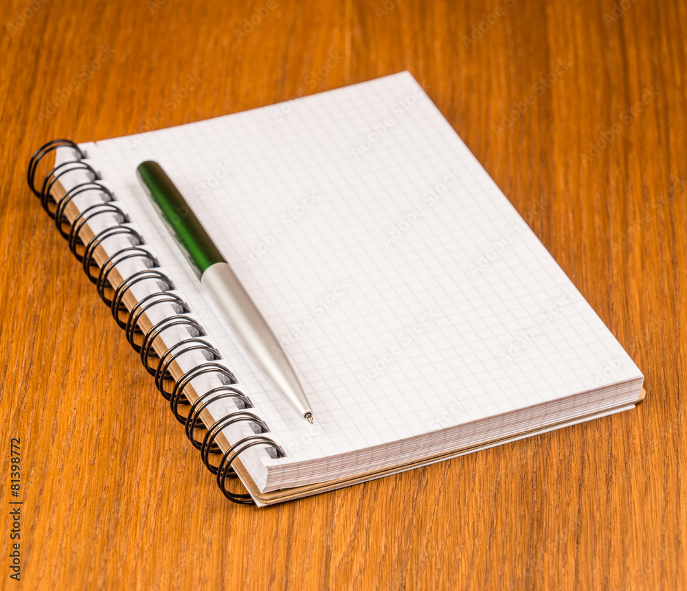 Blank notepad with pen on office wooden table. Blank notepad with pen on office wooden table.