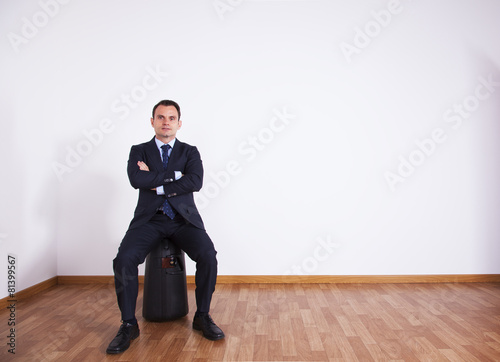 Businessman sit on his luggage