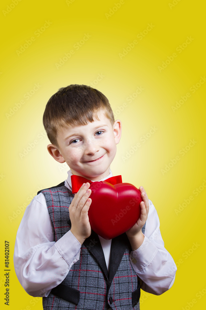 Happy, smiling little boy holding Red hear Happy, smiling little boy holding Red hear