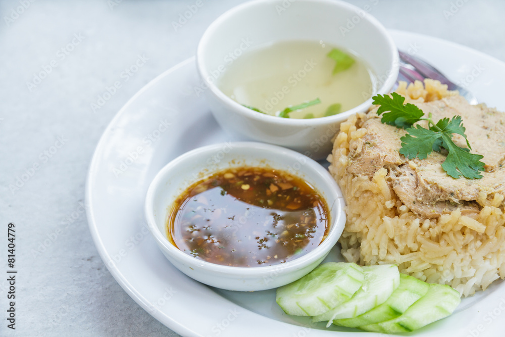 Rice roast chicken with spoon and fork on white plate. Rice roast chicken with spoon and fork on white plate.