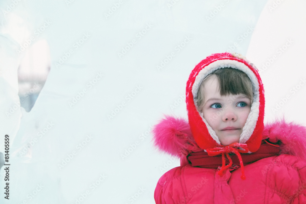 Little happy girl in red warm clothes looks away at winter day Little happy girl in red warm clothes looks away at winter day