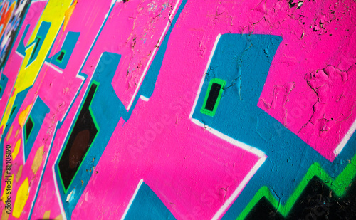 Abstract colorful graffiti fragment over old wall
