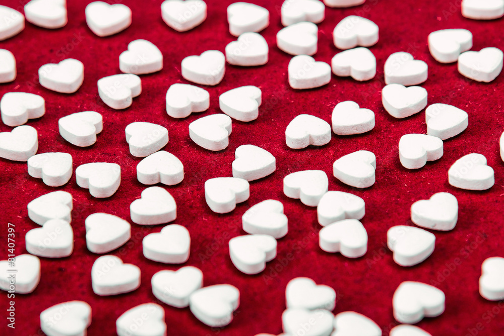 Small white hearts on red background Small white hearts on red background