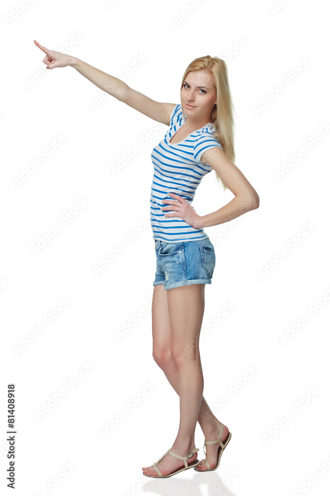 Happy young denim girl in shorts standing casually in full lengt