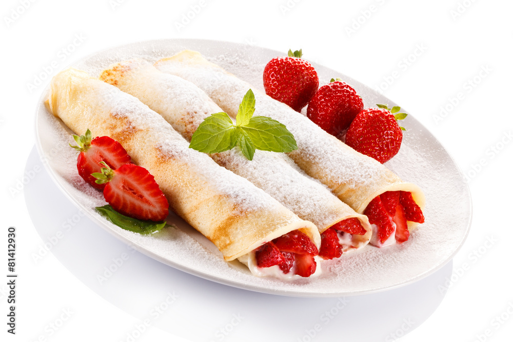 Crepes with strawberries and cream on white background Crepes with strawberries and cream on white background