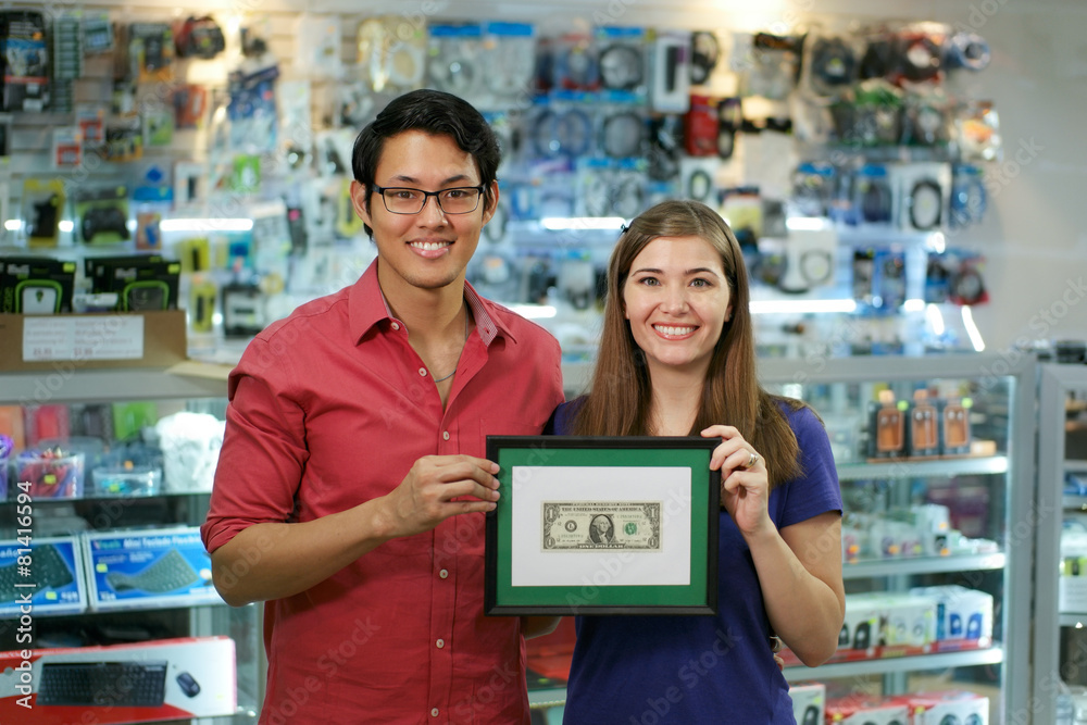 Portrait Of Happy Shop Owners Showing First Dollar Earning