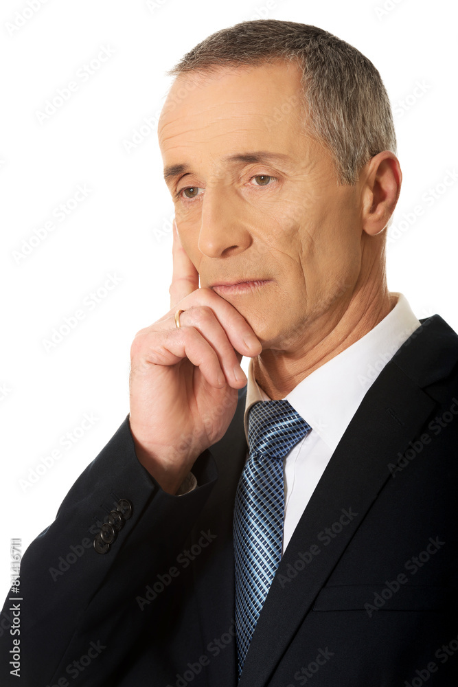 Portrait of a pensive businessman touching chin Portrait of a pensive businessman touching chin