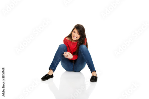 Relaxing woman sitting on the floor.