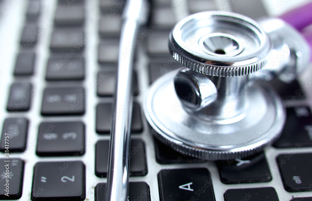 Violet stethoscope on a laptop computer Violet stethoscope on a laptop computer