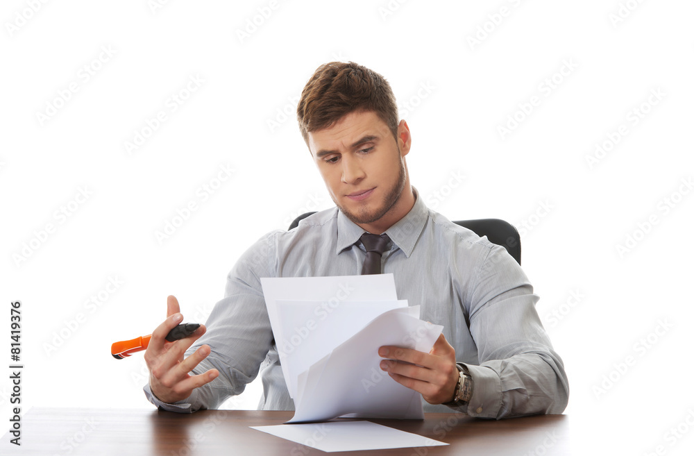Young business man viewing documents. Young business man viewing documents.