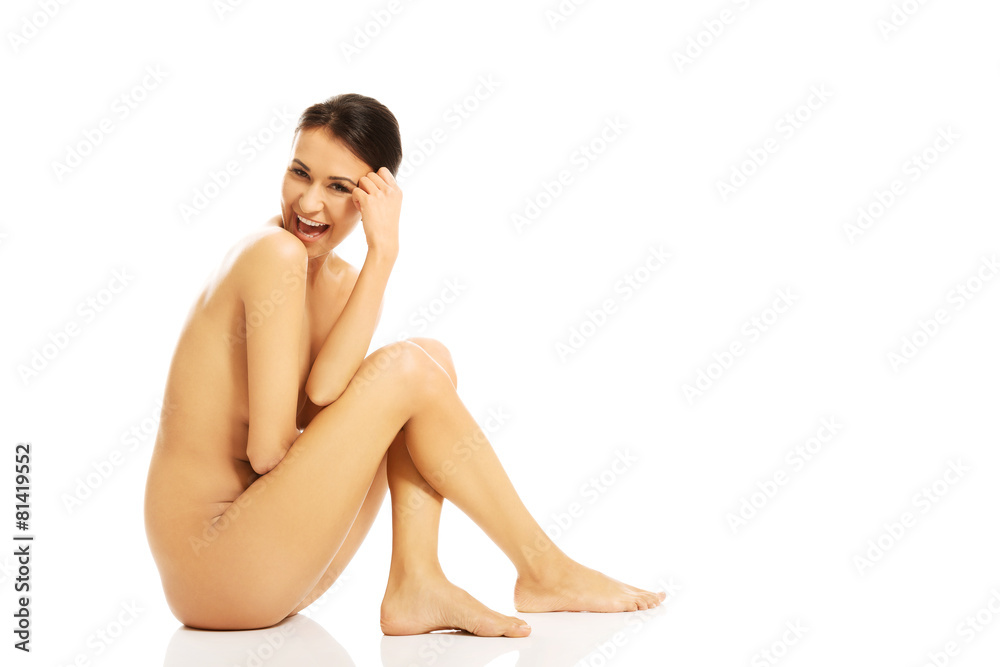 Nude woman sitting and looking down Nude woman sitting and looking down