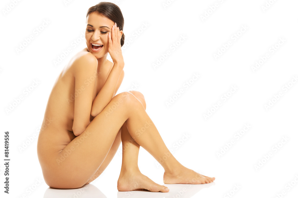 Nude woman sitting and looking down