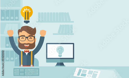 Happy young man at his computer
