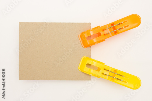Cardboard with Yellow and Orange Clothes Pins