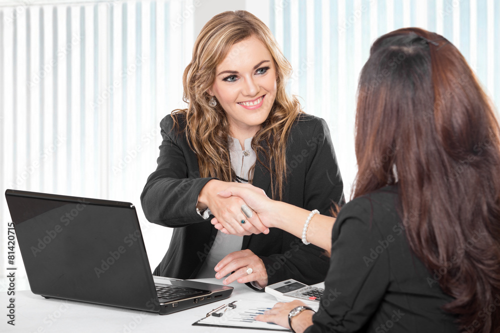 Two young businesswoman shaking hand Two young businesswoman shaking hand
