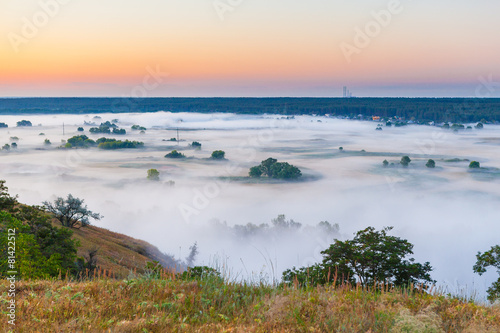 Misty dawn over Valley and the forest