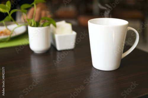 white coffee cup on breakfast wooden desk with copyspace