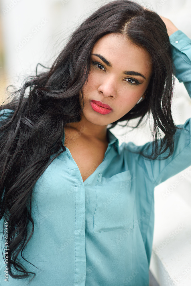 Hispanic young woman wearing casual clothes in urban background Hispanic young woman wearing casual clothes in urban background