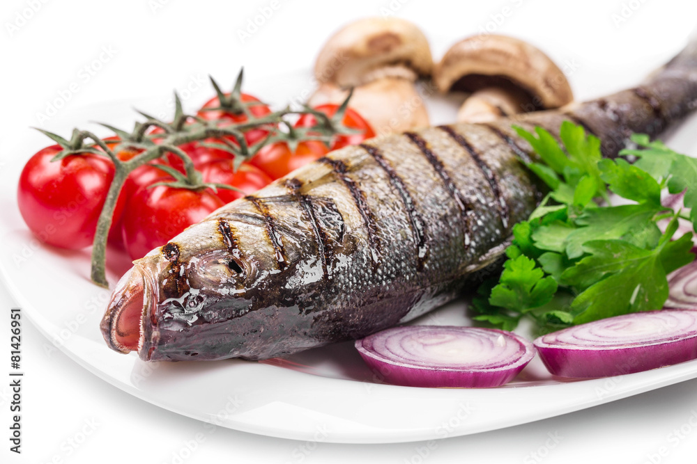 Grilled seabass on plate with tomatoes. Grilled seabass on plate with tomatoes.