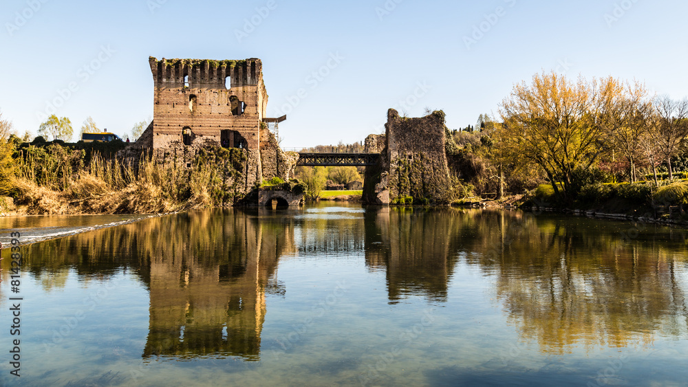 old and ruined castle on a lake in the italian countryside
