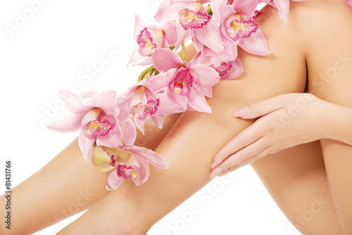 Woman legs with pink flowers.