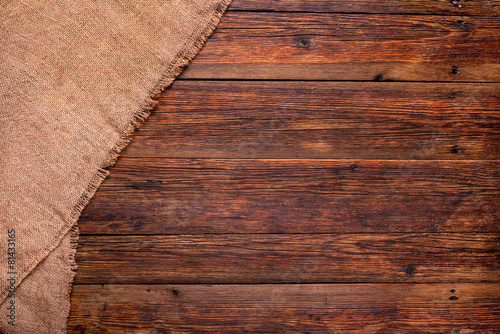 wooden table with burlap texture background photo