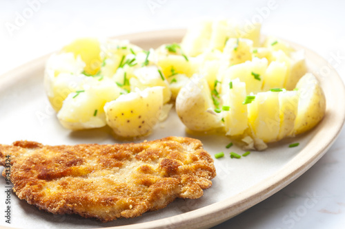 fried pork fillet with boiled unpeeled potatoes