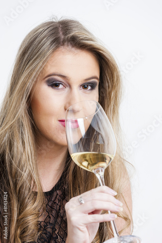 portrait of young woman with a glass of white wine
