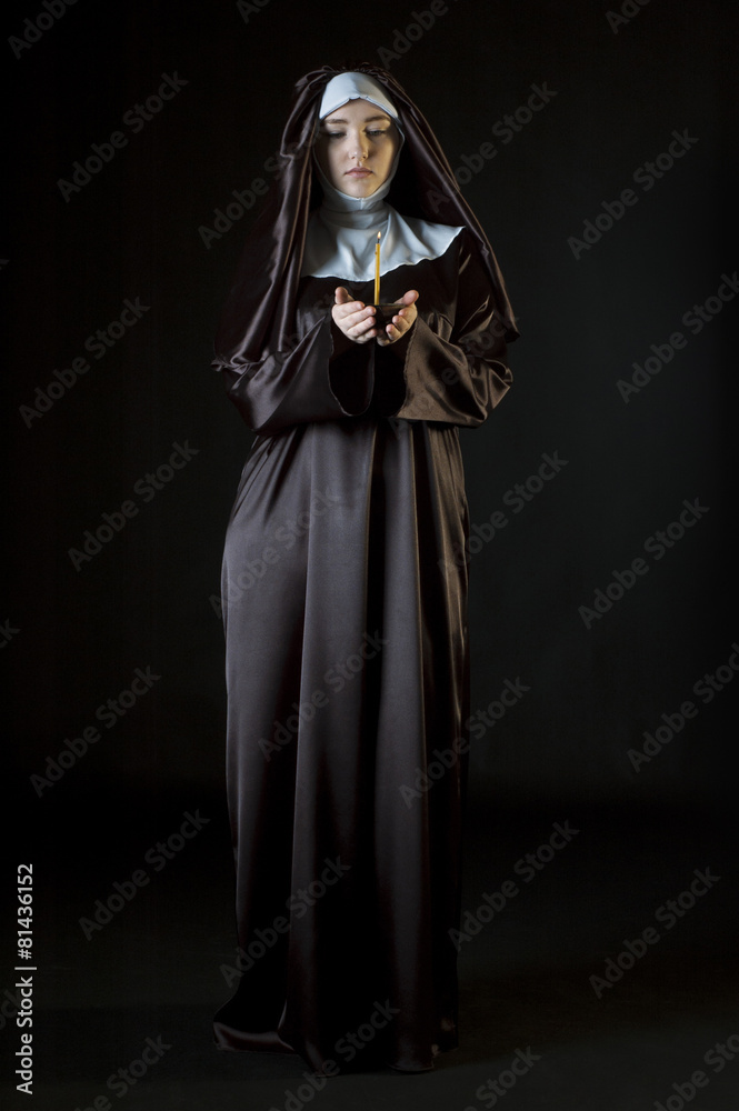 Nun holding candle
