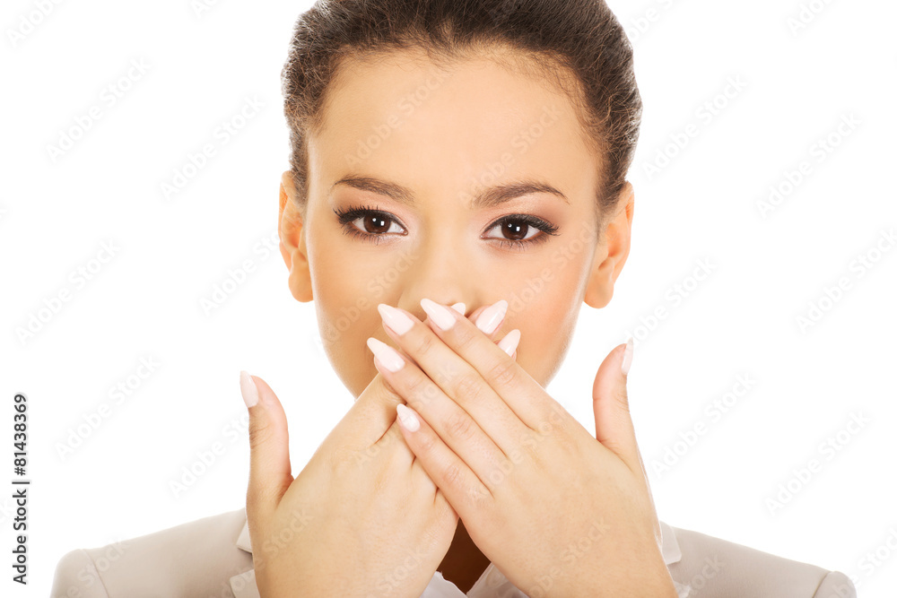 Businesswoman covering mouth with hands. Businesswoman covering mouth with hands.