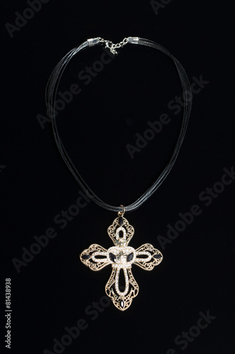 necklace with cross isolated on black background