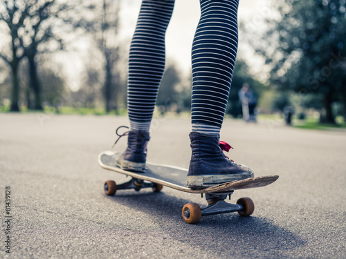 Legs of person skateboarding in the park