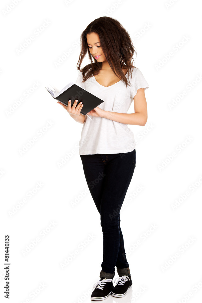 Young student woman reading book. Young student woman reading book.