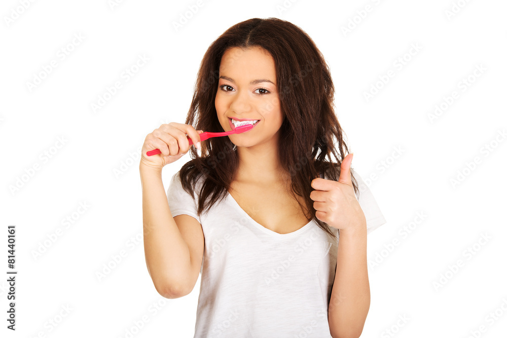 Beautiful teen brushing her teeth. Beautiful teen brushing her teeth.