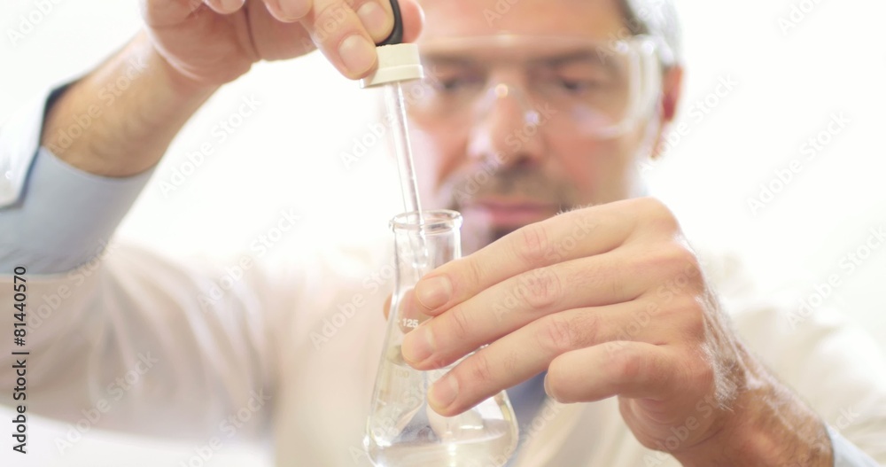 A scientist in a lab testing water hardness A scientist in a lab testing water hardness