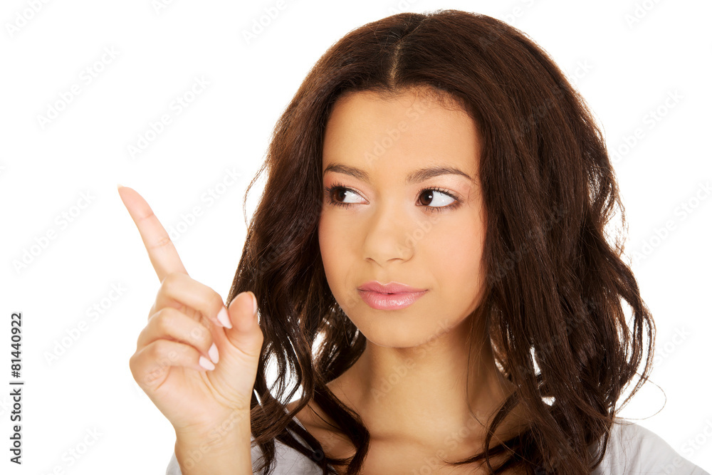 Young woman pointing up.