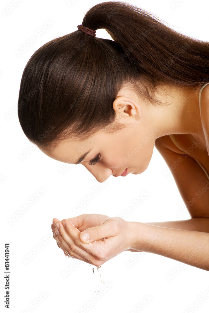 Fototapeta premium Woman washing her clean face.