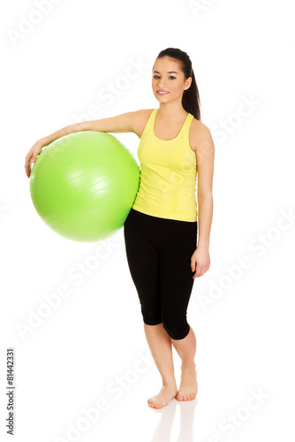 Young woman with pilates ball. © Piotr Marcinski