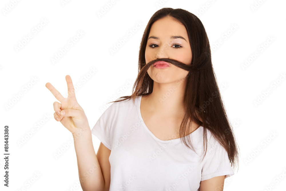 Teen woman putting hair like moustache.