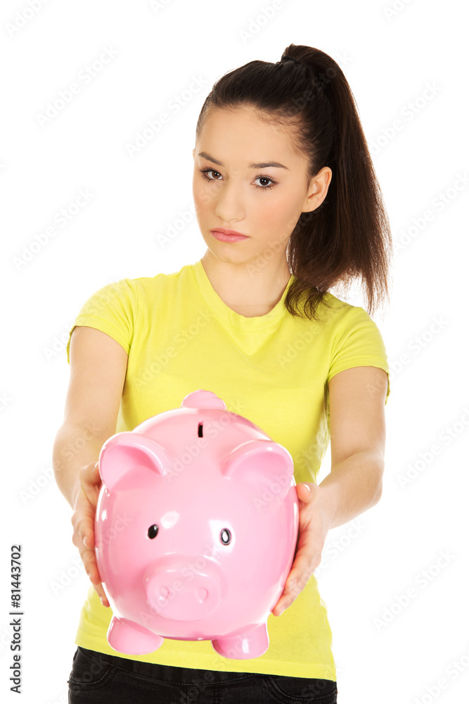 Unhappy woman holding piggybank. Unhappy woman holding piggybank.