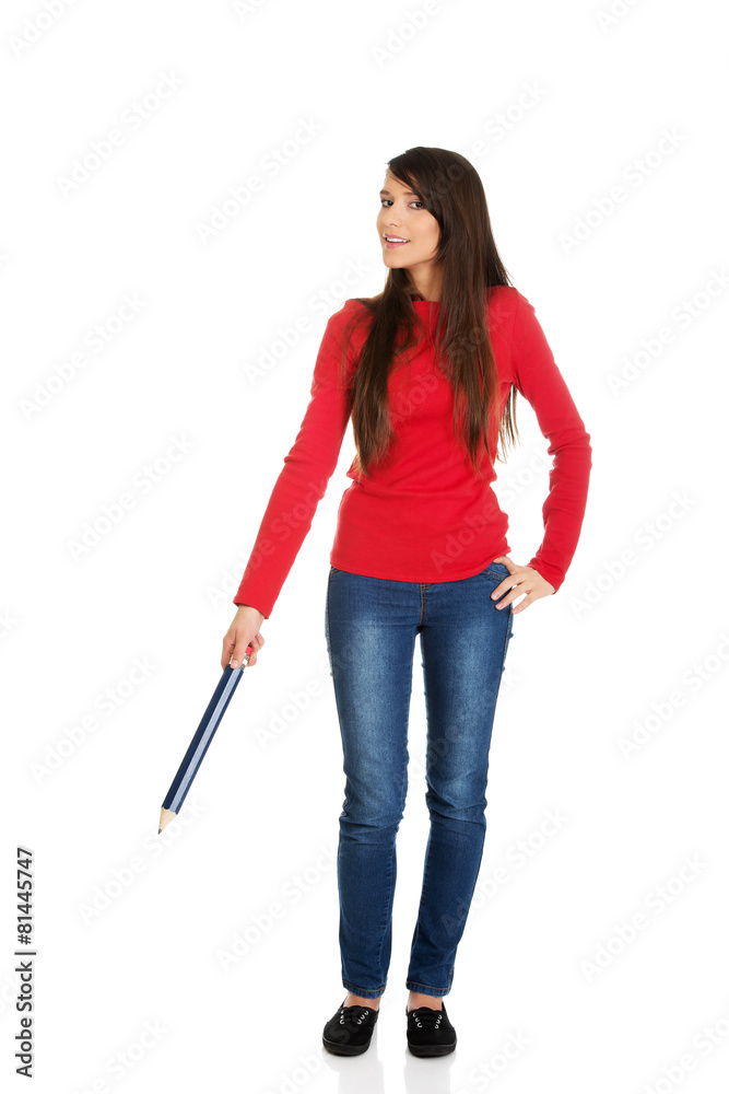 Beautiful woman pointing down with a big pencil.