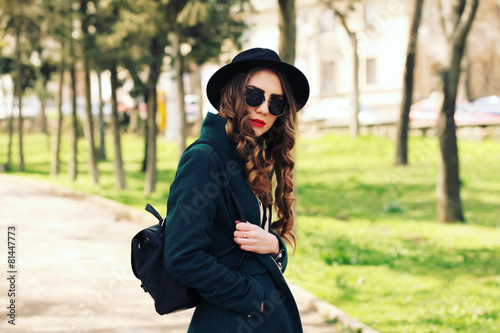 Outdoor fashion portrait of stylish pretty hipster girl