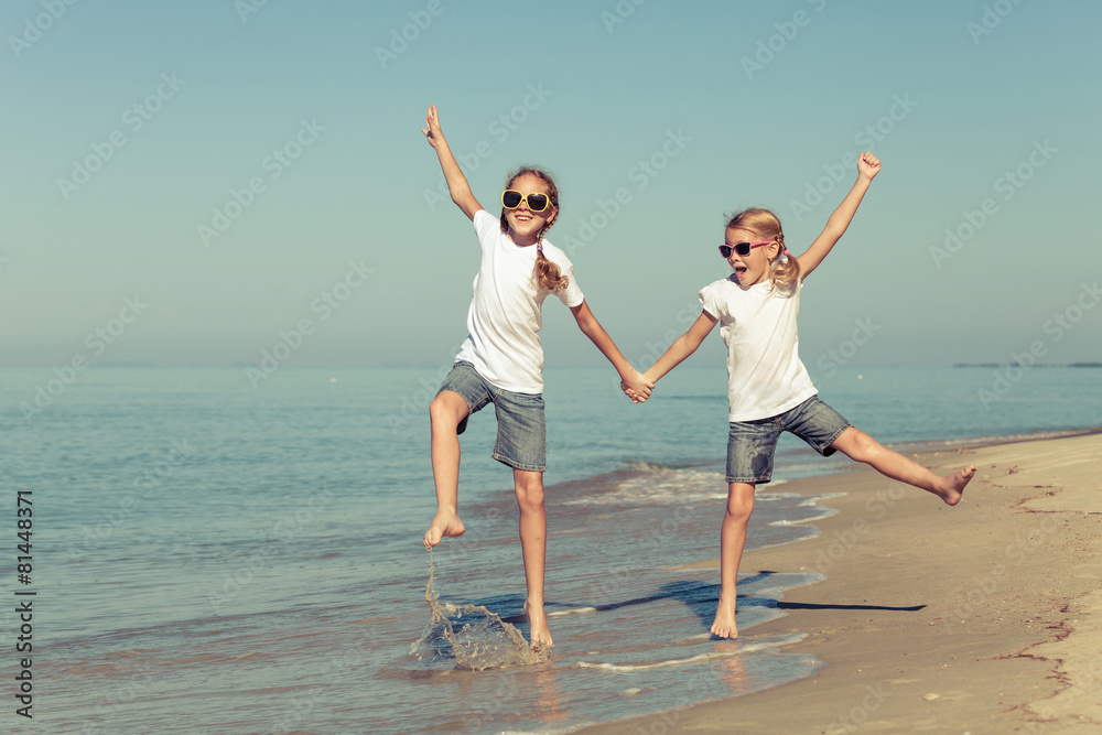 two sisters playing on the beach