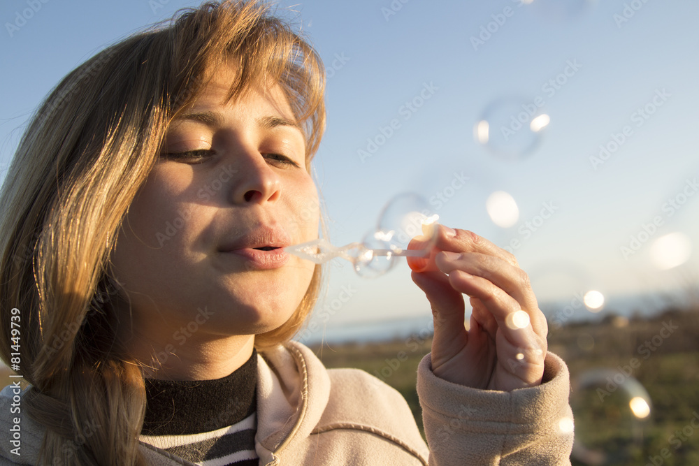 young girl blow bubbles in field young girl blow bubbles in field